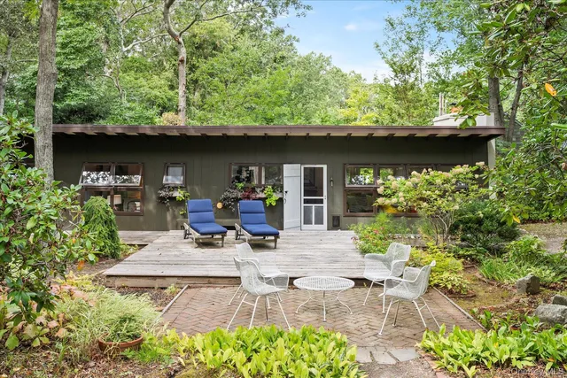 a view of backyard with outdoor seating and green space