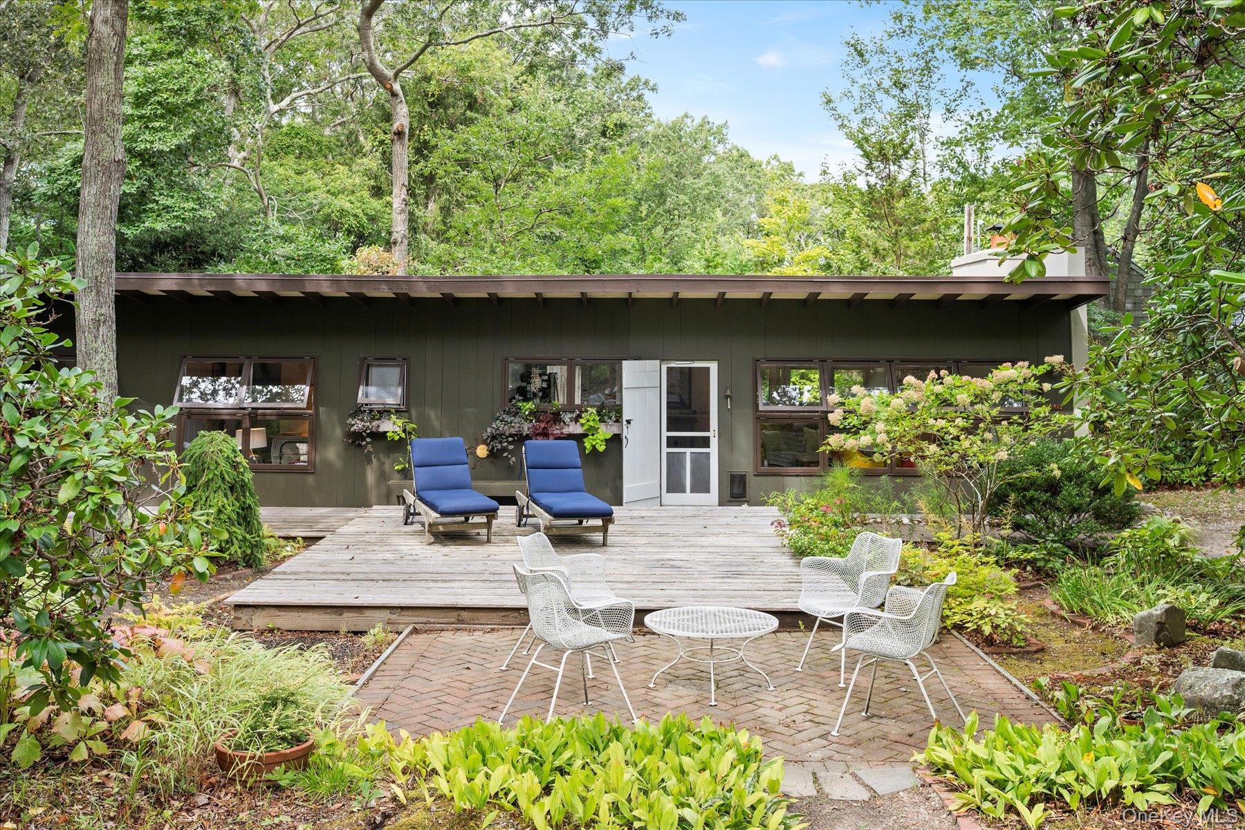 a view of backyard with outdoor seating and green space