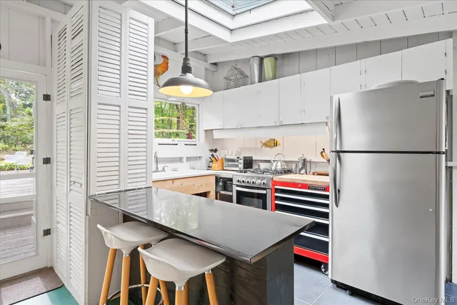a kitchen with a refrigerator and a table