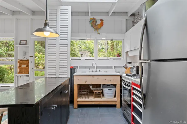 a utility room with stainless steel appliances and furniture