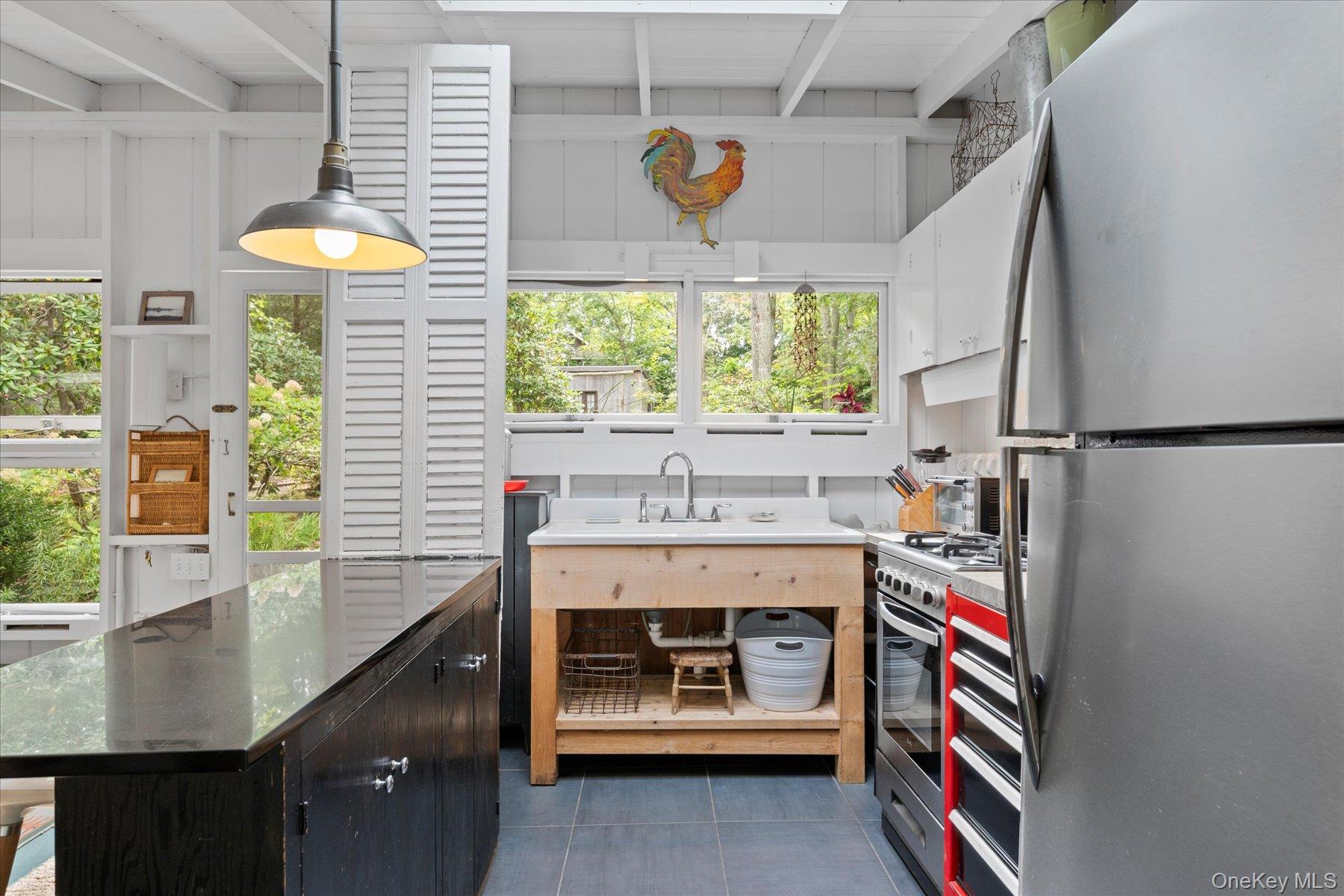 46 Flaggy Hole Road East Hampton, NY 11937 - Photo 12 of 32 a utility room with stainless steel appliances and furniture