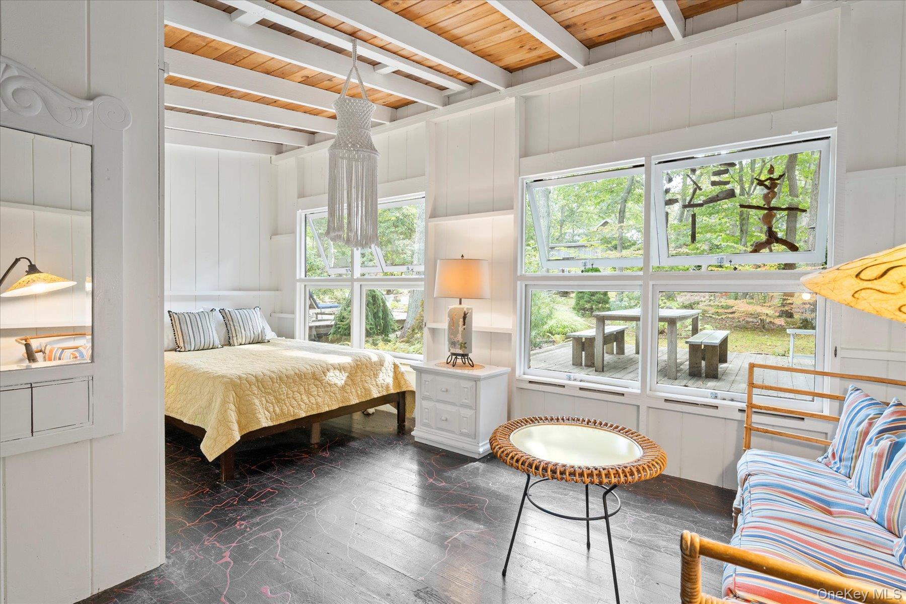 46 Flaggy Hole Road East Hampton, NY 11937 - Photo 16 of 32 a spacious bedroom with a bed a table and chair with the large mirror