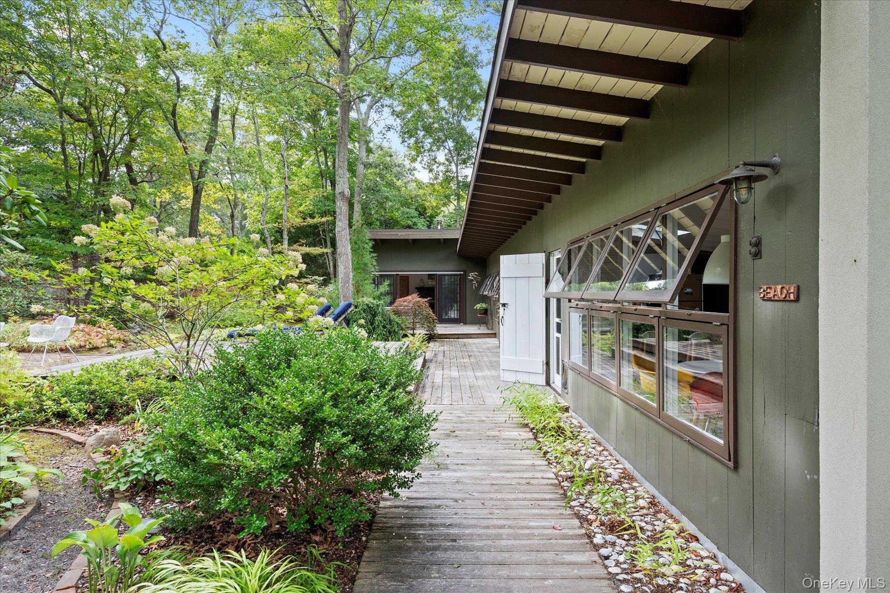 46 Flaggy Hole Road East Hampton, NY 11937 - Photo 2 of 32 a view of a porch with wooden floor