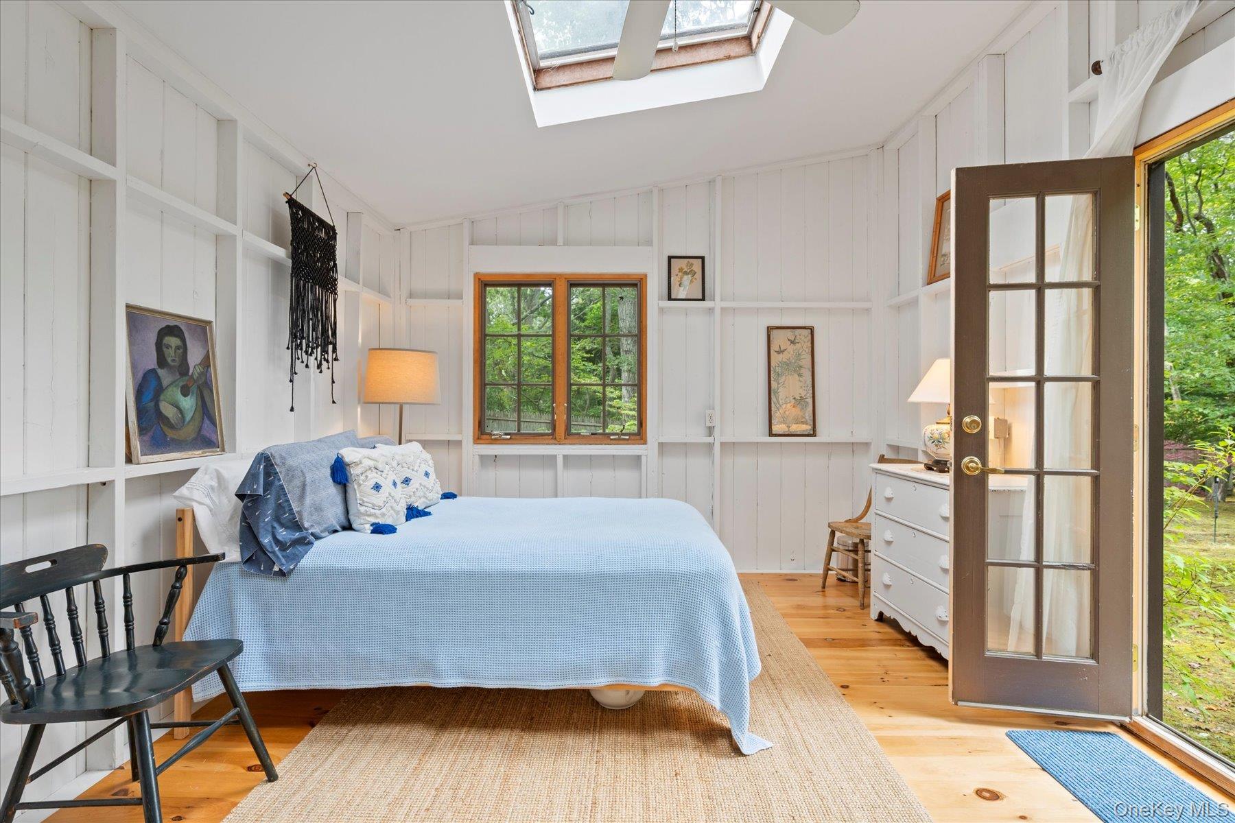 46 Flaggy Hole Road East Hampton, NY 11937 - Photo 22 of 32 a bedroom with a bed wooden floor and a table