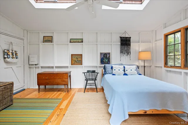 a bedroom with furniture and a lamp