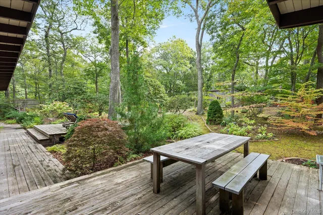 a view of a wooden chairs and table in the terrace