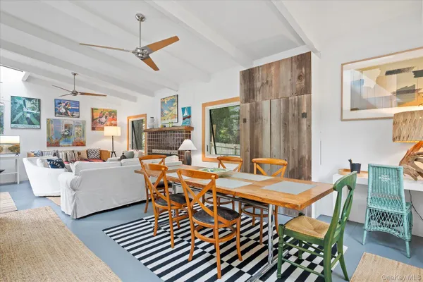 a dining room with furniture a rug and wooden floor