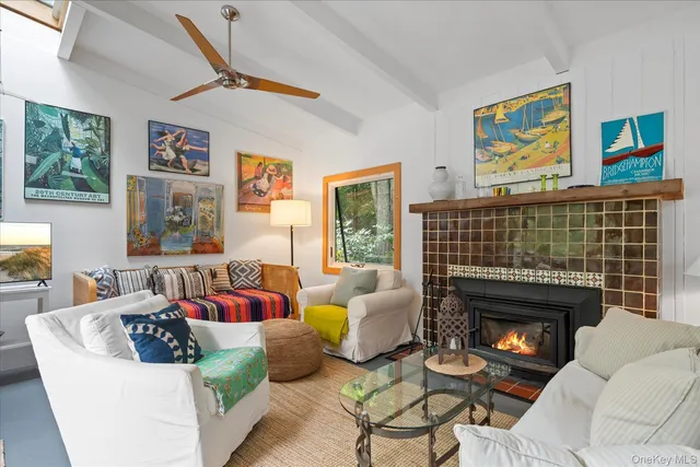 a living room with furniture a fireplace and a large window