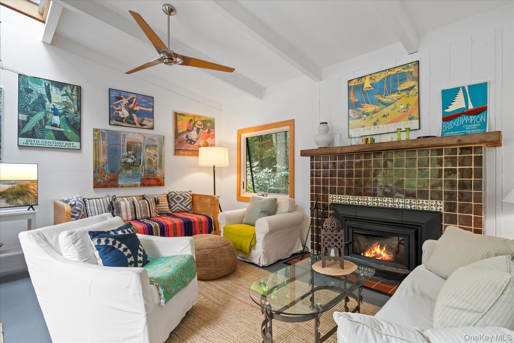 46 Flaggy Hole Road East Hampton, NY 11937 - Photo 5 of 32 a living room with furniture a fireplace and a large window