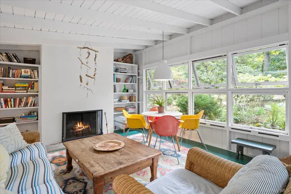a living room with furniture a fireplace and a large window