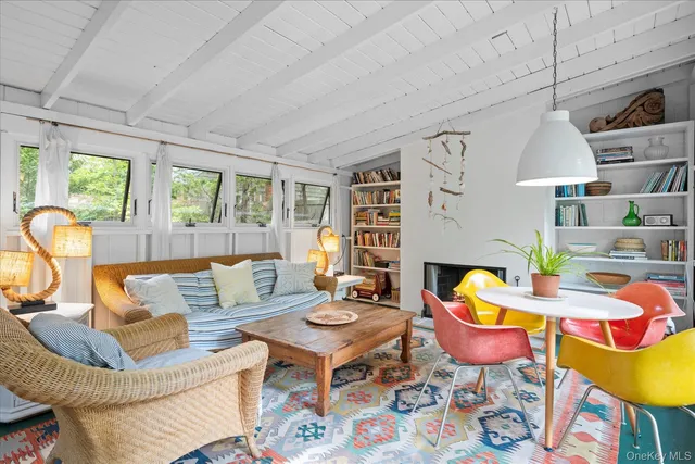 a living room with fireplace furniture and a large window