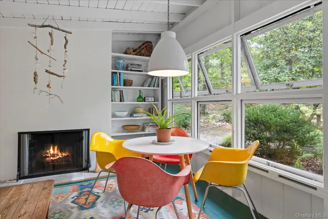 a dining room with furniture a fireplace and wooden floor