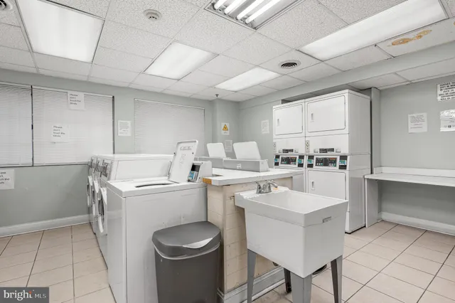 a kitchen with a sink a stove cabinets and counter space
