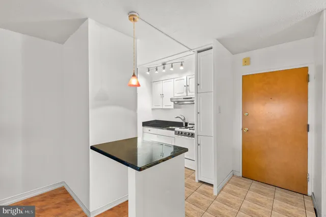a kitchen with stainless steel appliances granite countertop a sink and a refrigerator