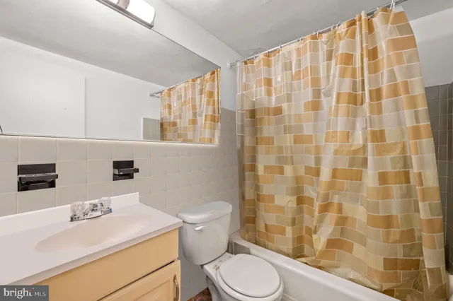 a bathroom with a sink toilet vanity and shower