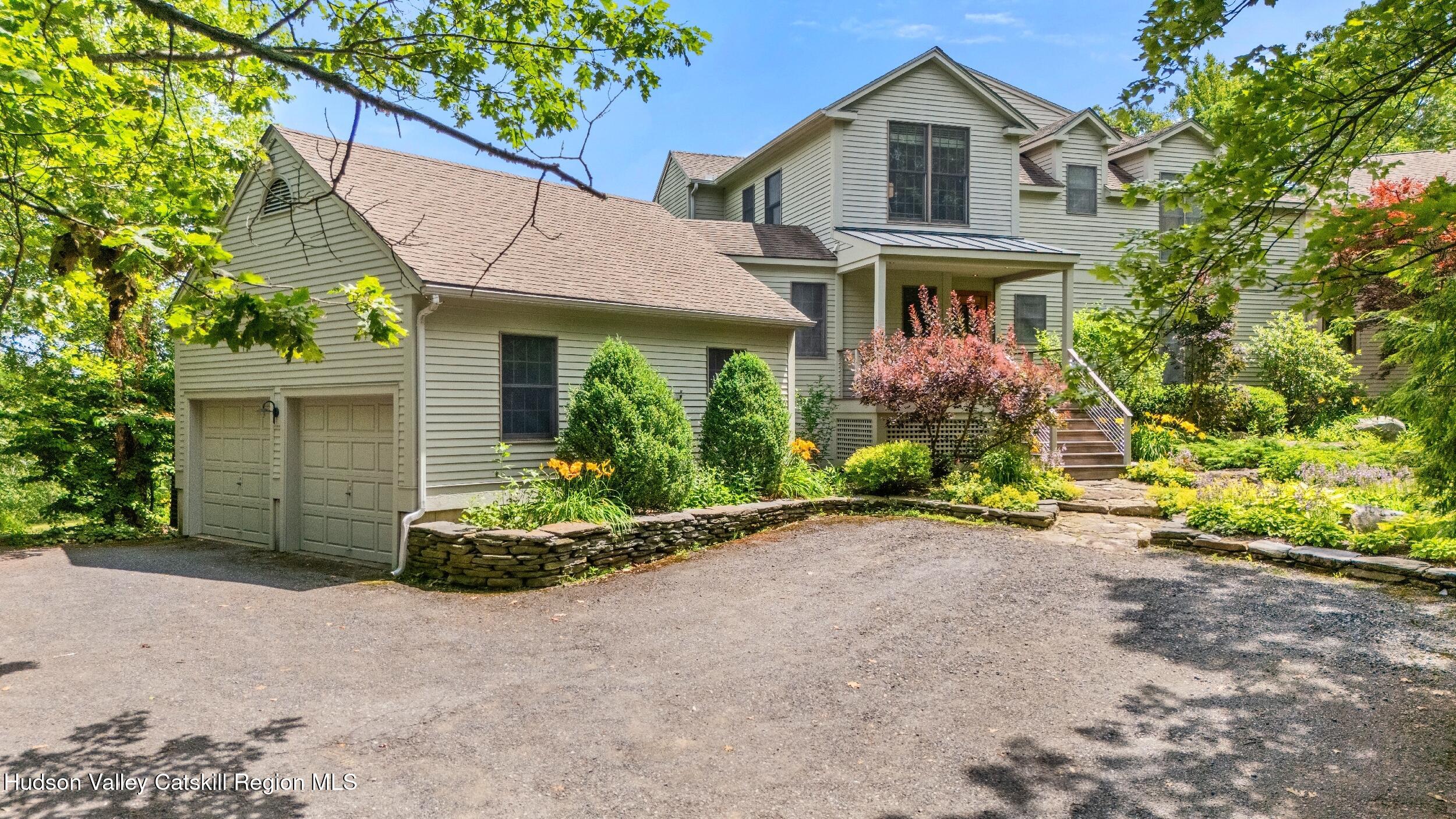 74 Oak Ridge Canaan, NY 12029 - Photo 2 of 54 a front view of a house with a garden