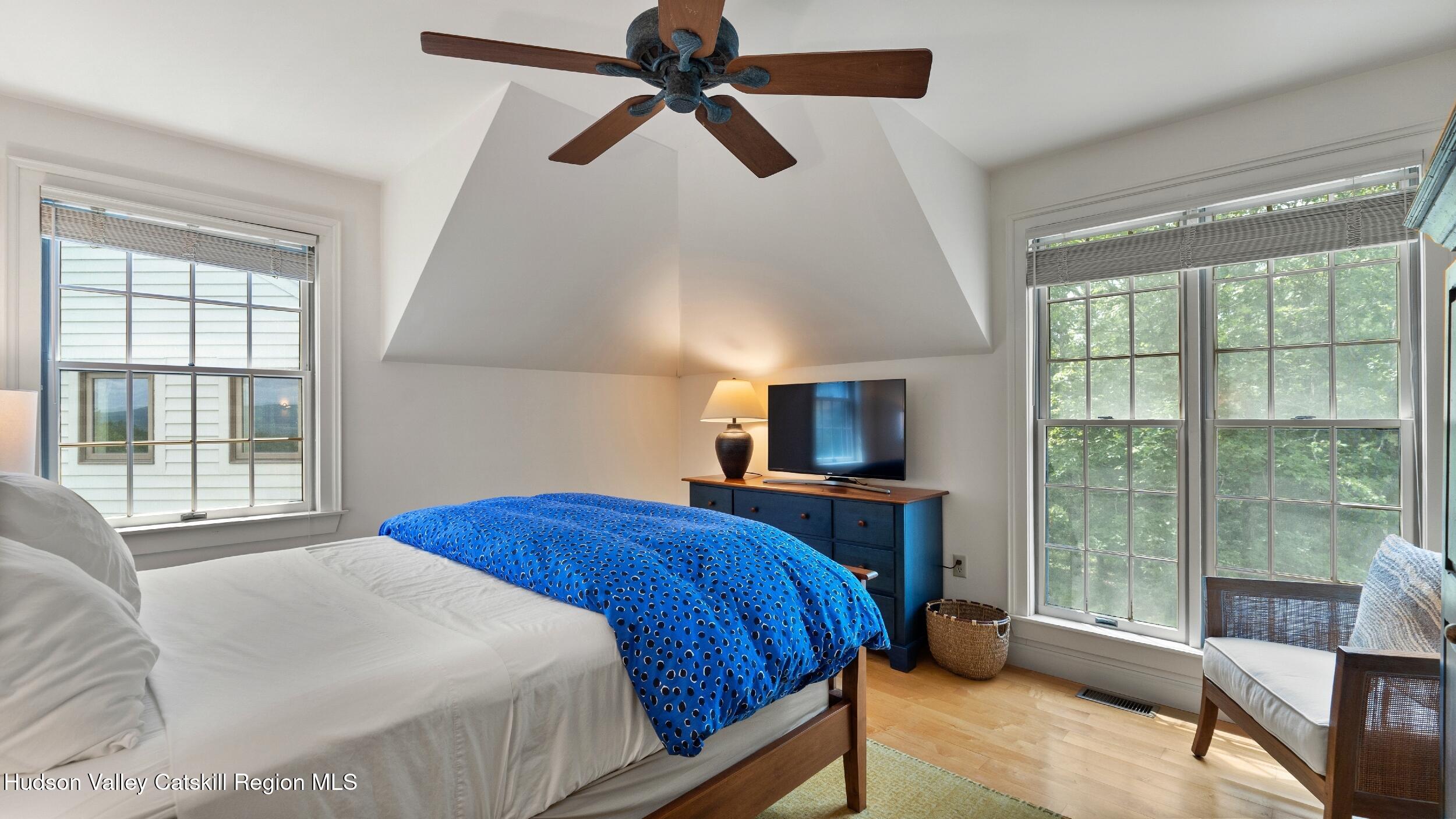 74 Oak Ridge Canaan, NY 12029 - Photo 30 of 54 a bedroom with a bed a flat screen tv and a large window