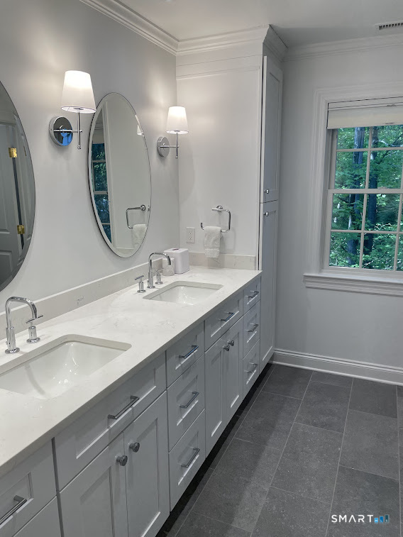 9 Tory Hole Road Darien, CT 06820 - Photo 15 of 33 a spacious bathroom with double vanity a mirror and a window