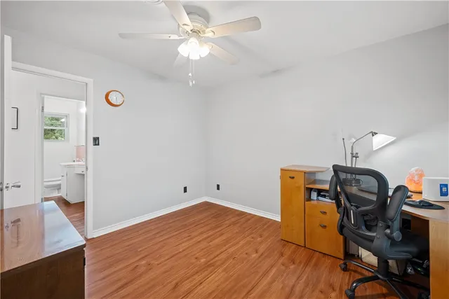 a view of a workspace with wooden floor