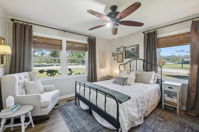 a bedroom with a bed couch and a large window