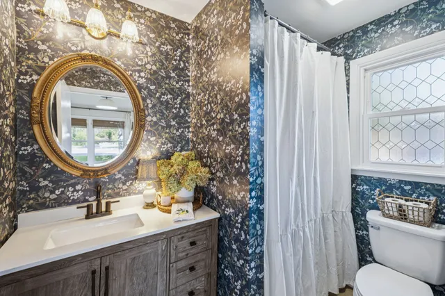 a bathroom with a sink a mirror and a toilet