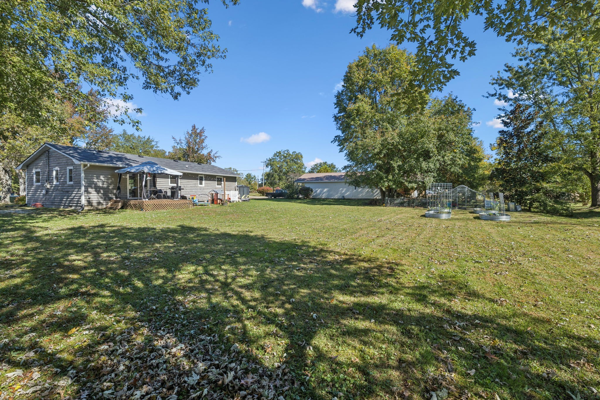 440 West Maple Street Morrison, TN 37357 - Photo 22 of 24 a view of a house with a big yard and large trees
