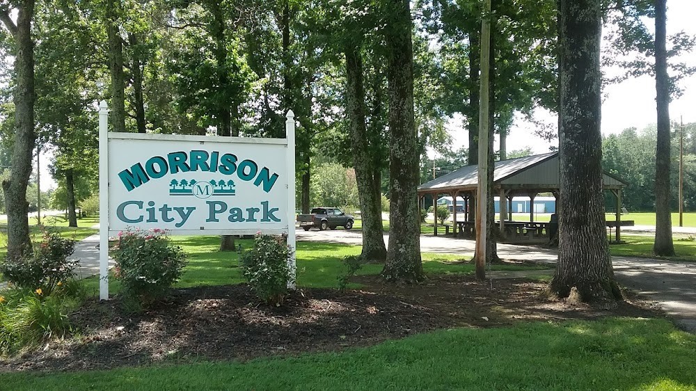 440 West Maple Street Morrison, TN 37357 - Photo 24 of 24 a sign that is sitting on a brick wall with large trees