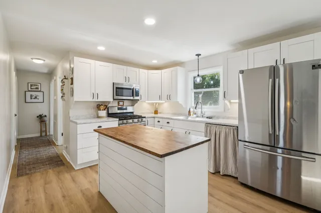 a kitchen with a refrigerator sink and microwave