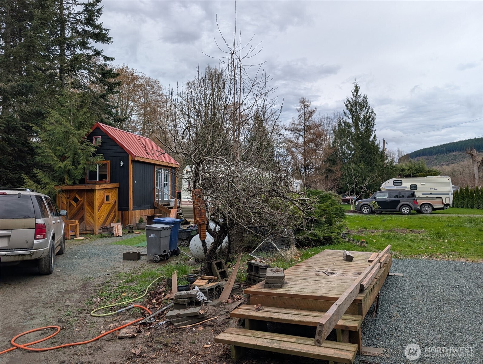 a view of a house with backyard and sitting area