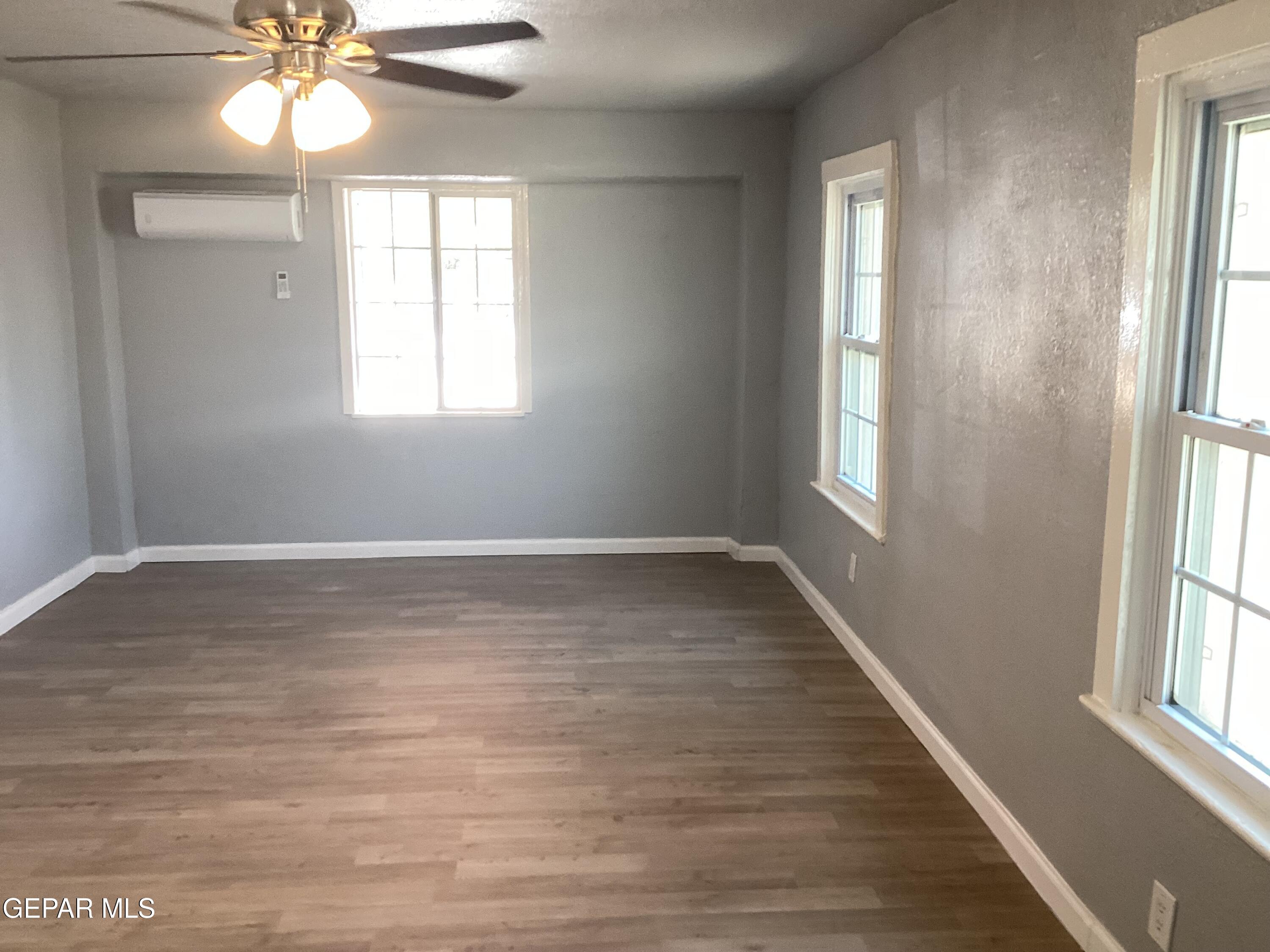 8405 Pinon Street El Paso, TX 79907 - Photo 11 of 21 a view of an empty room with wooden floor and a window