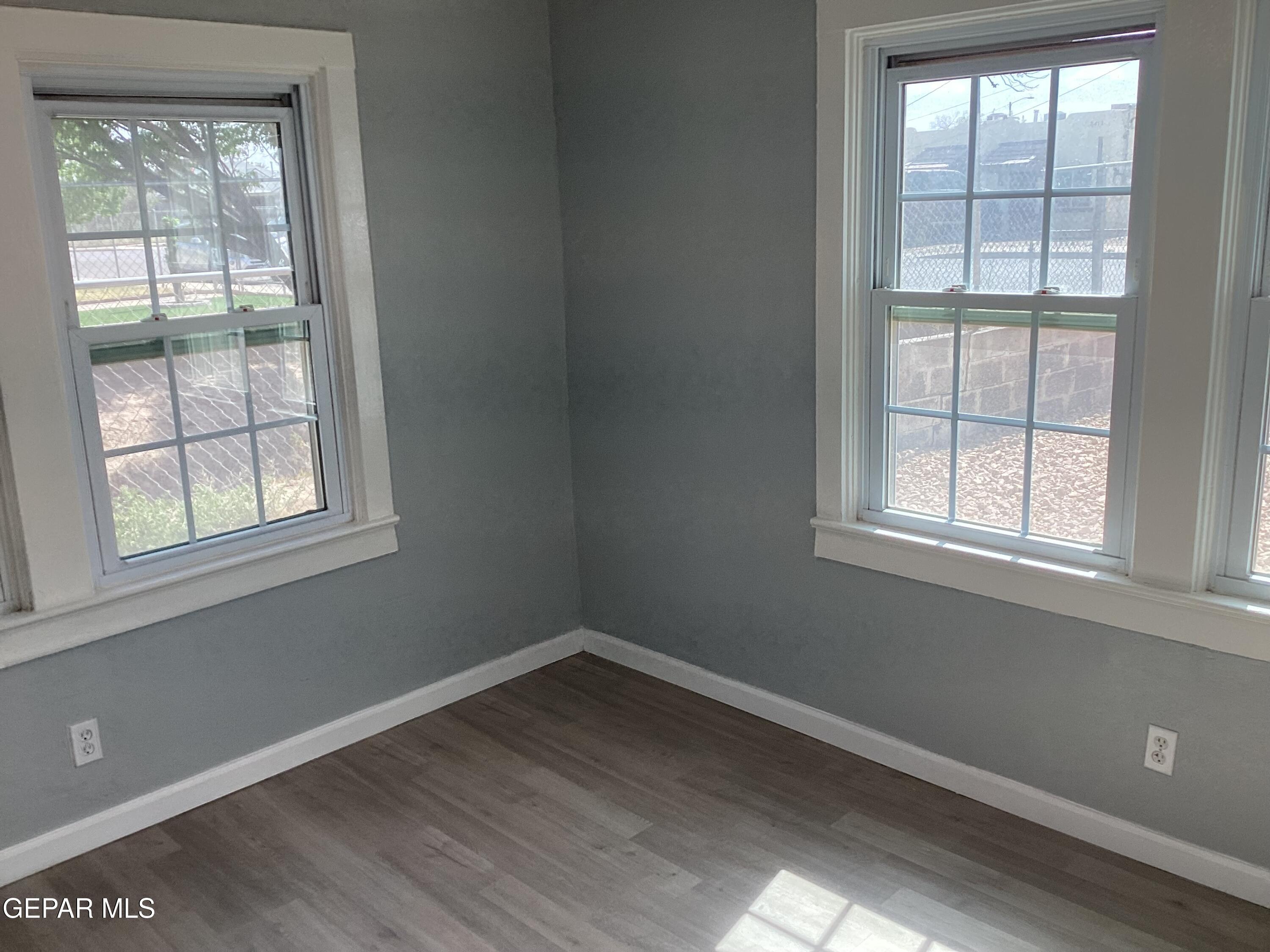 8405 Pinon Street El Paso, TX 79907 - Photo 12 of 21 an empty room with wooden floor and windows