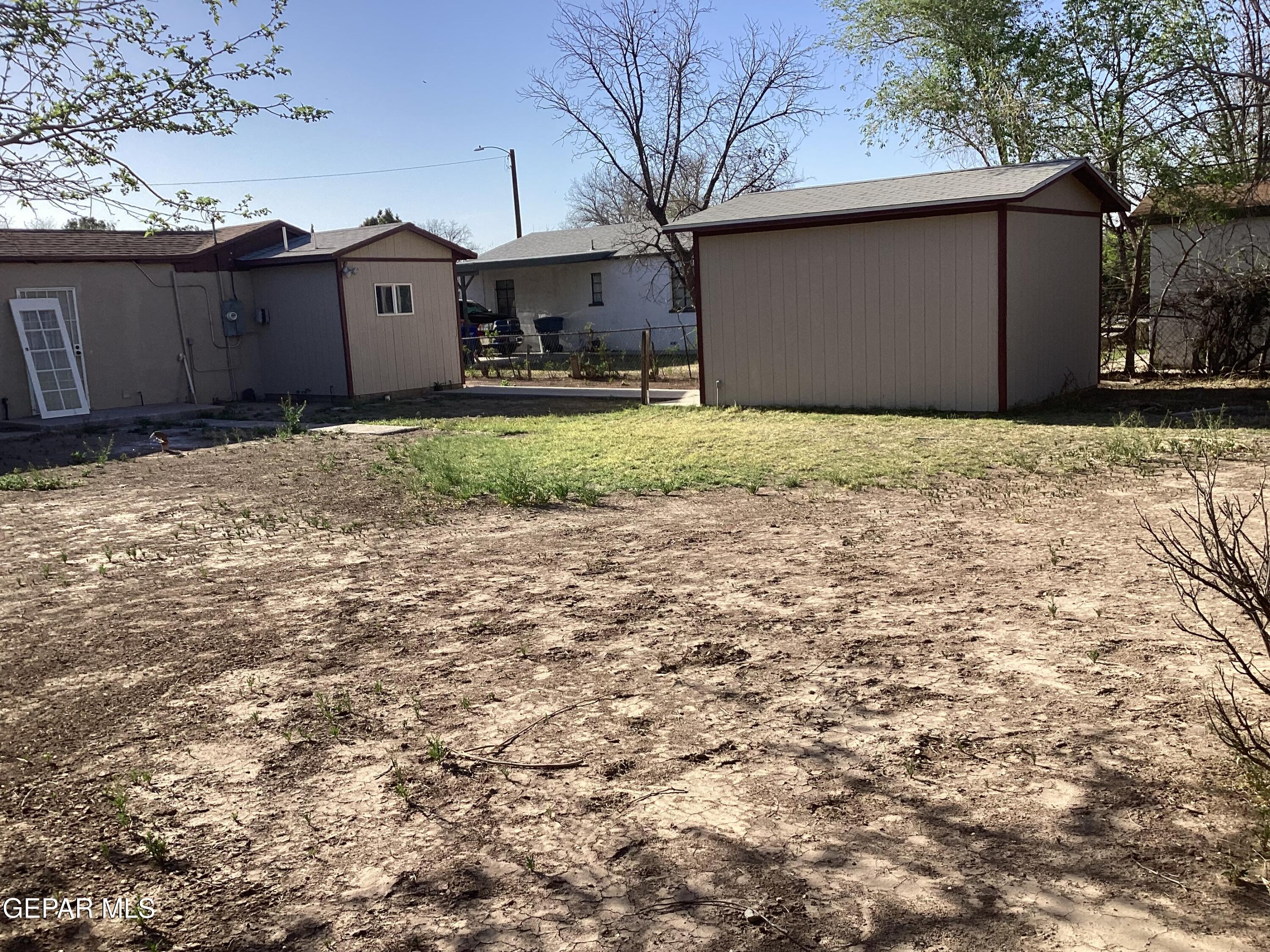8405 Pinon Street El Paso, TX 79907 - Photo 16 of 21 a front view of a house with a yard and garage