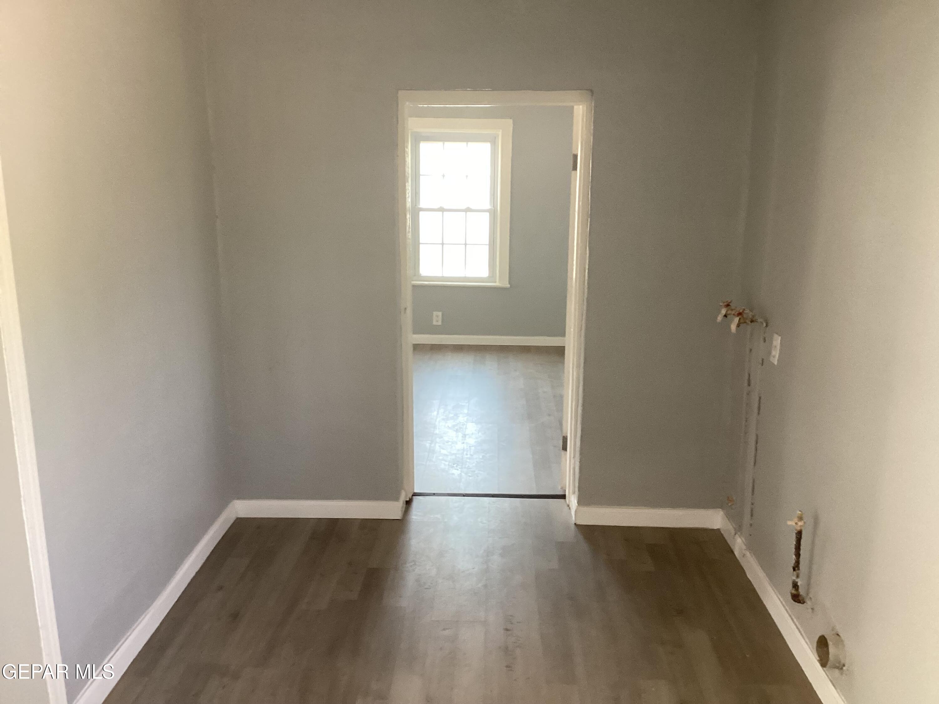 8405 Pinon Street El Paso, TX 79907 - Photo 5 of 21 an empty room with wooden floor and windows