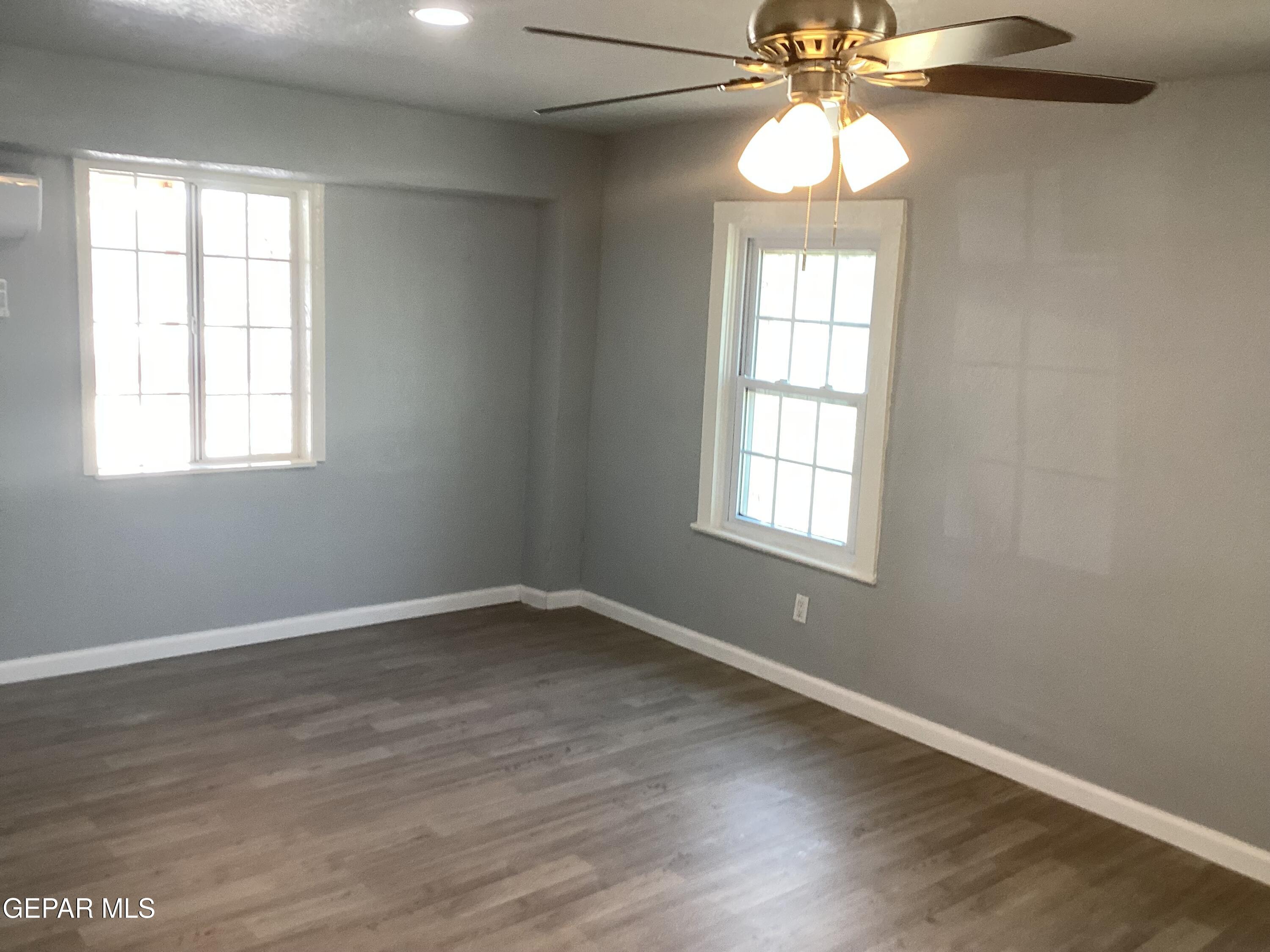 8405 Pinon Street El Paso, TX 79907 - Photo 6 of 21 wooden floor in an empty room with a window