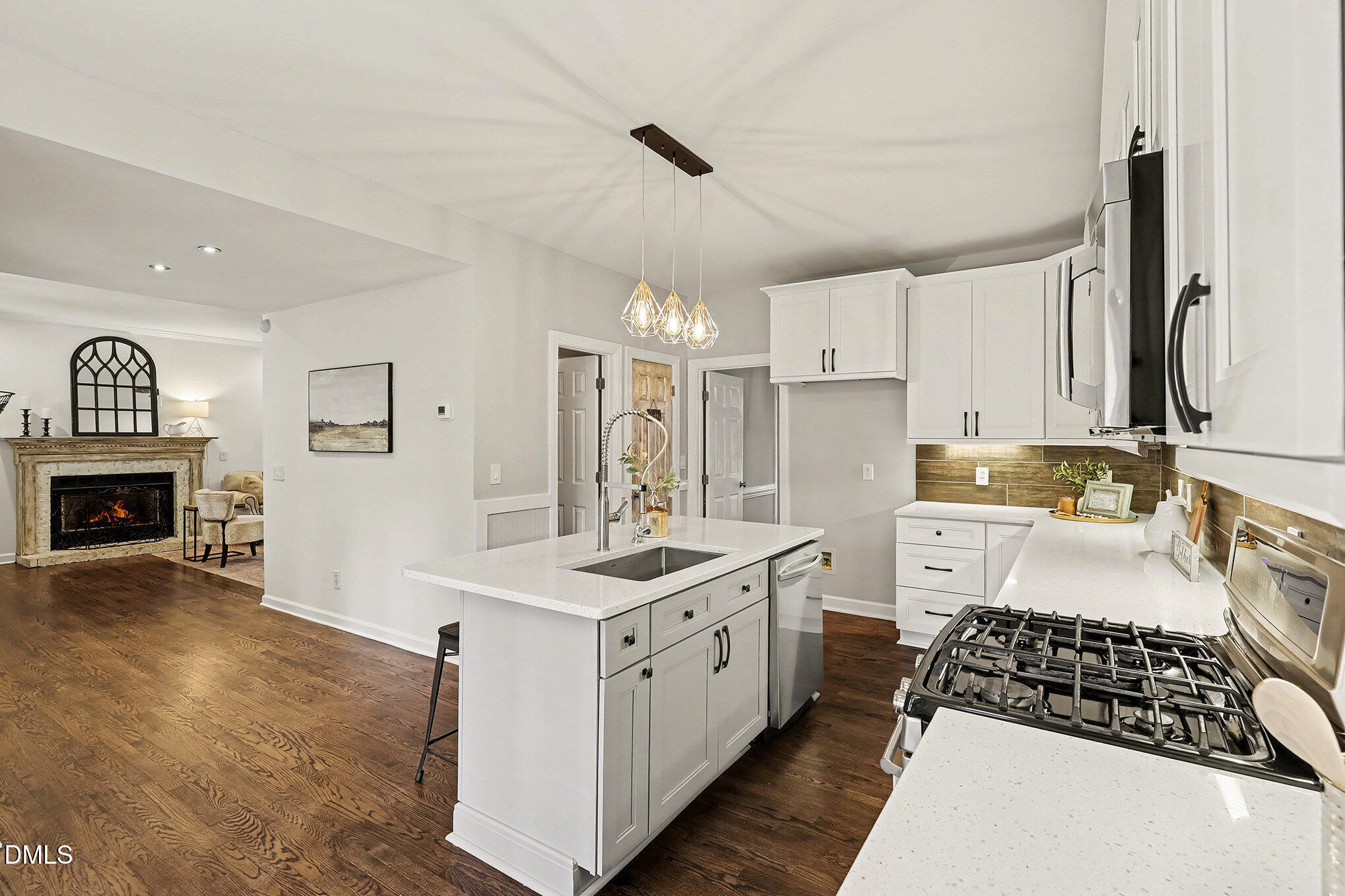 4121 Summer Ridge Court Apex, NC 27539 - Photo 12 of 29 a kitchen with a sink stove and cabinets