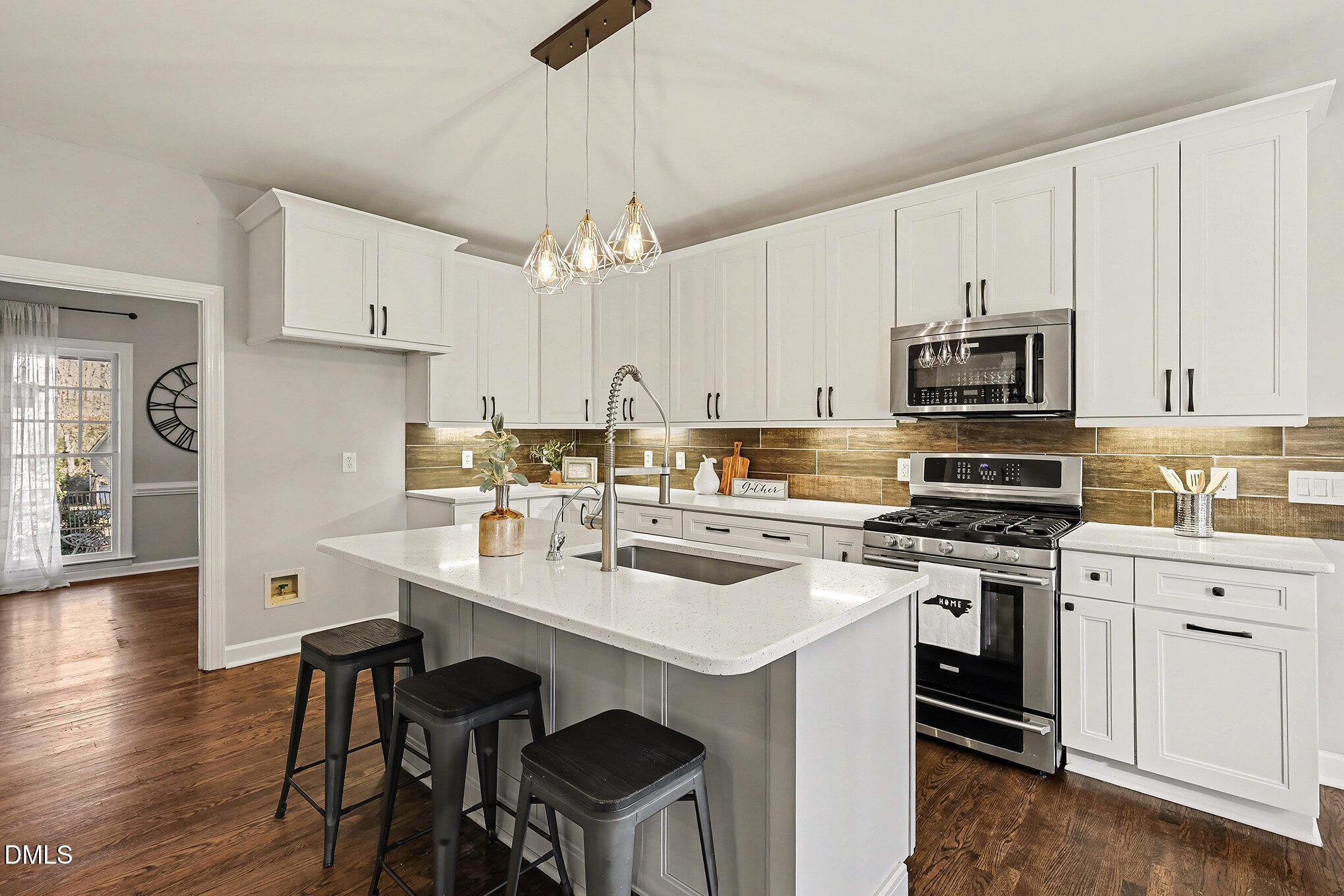 4121 Summer Ridge Court Apex, NC 27539 - Photo 13 of 29 a kitchen with a stove a sink and a refrigerator