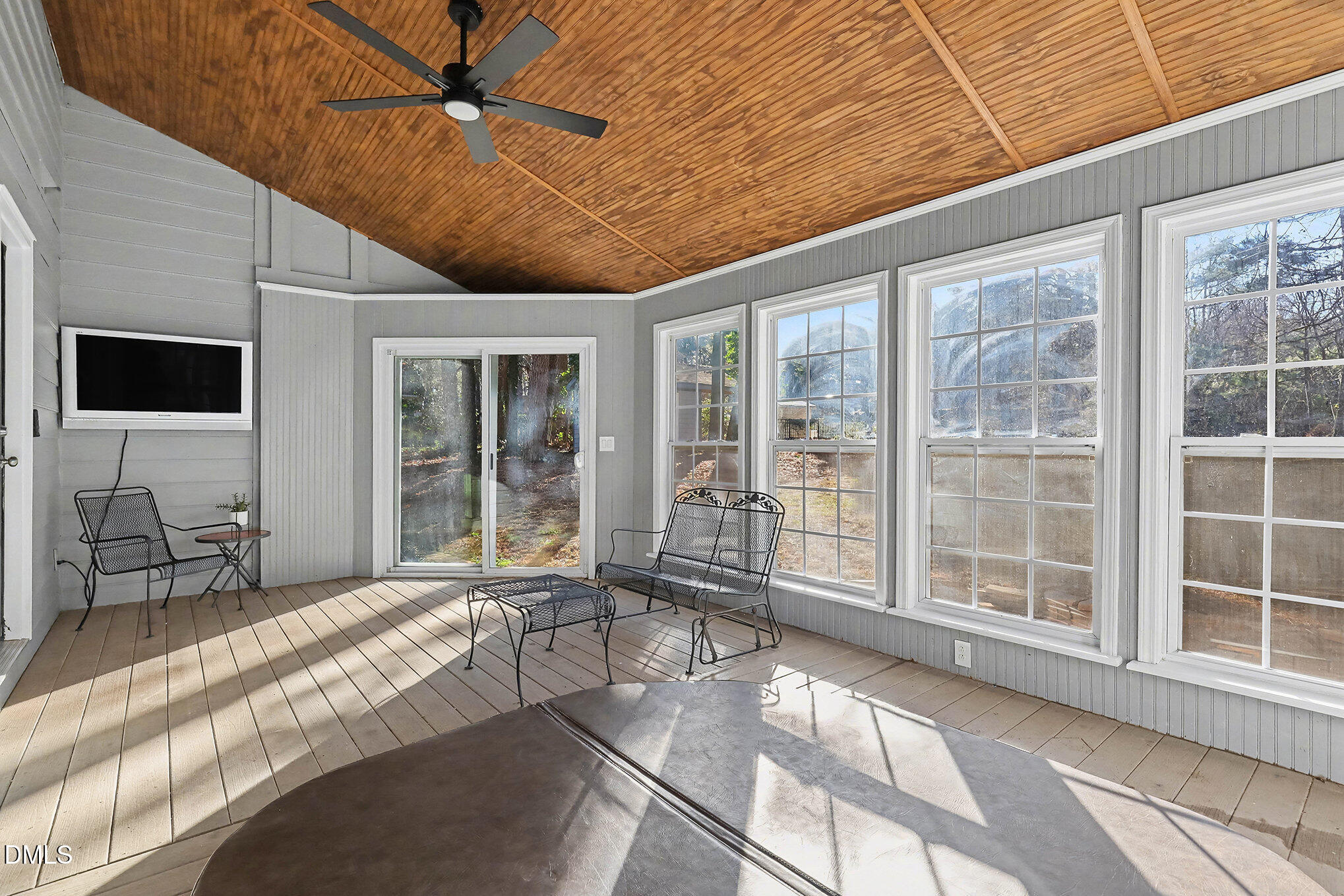 4121 Summer Ridge Court Apex, NC 27539 - Photo 28 of 29 a living room with furniture a flat screen tv and floor to ceiling window