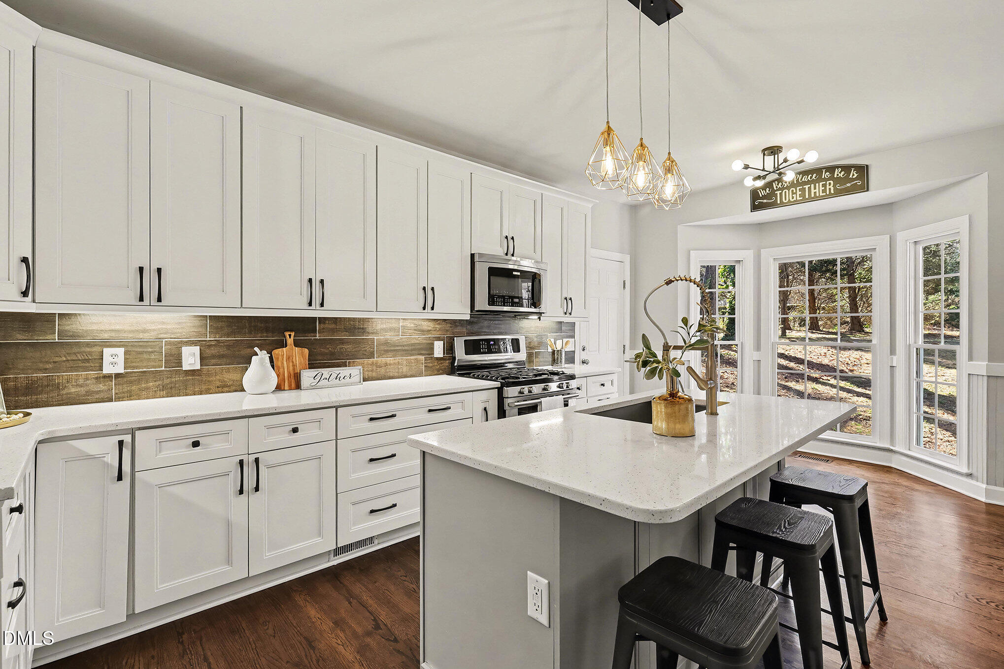 4121 Summer Ridge Court Apex, NC 27539 - Photo 9 of 29 a kitchen with white cabinets appliances and wooden floor