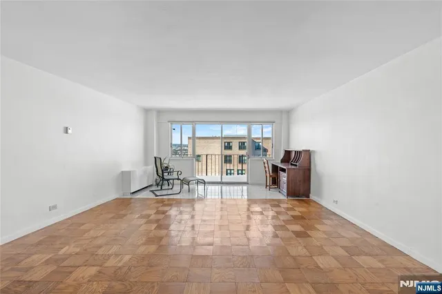 a view of a livingroom with a dinning area hardwood and a kitchen