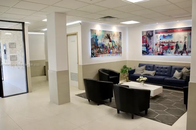 a living room with furniture and a painting on the wall