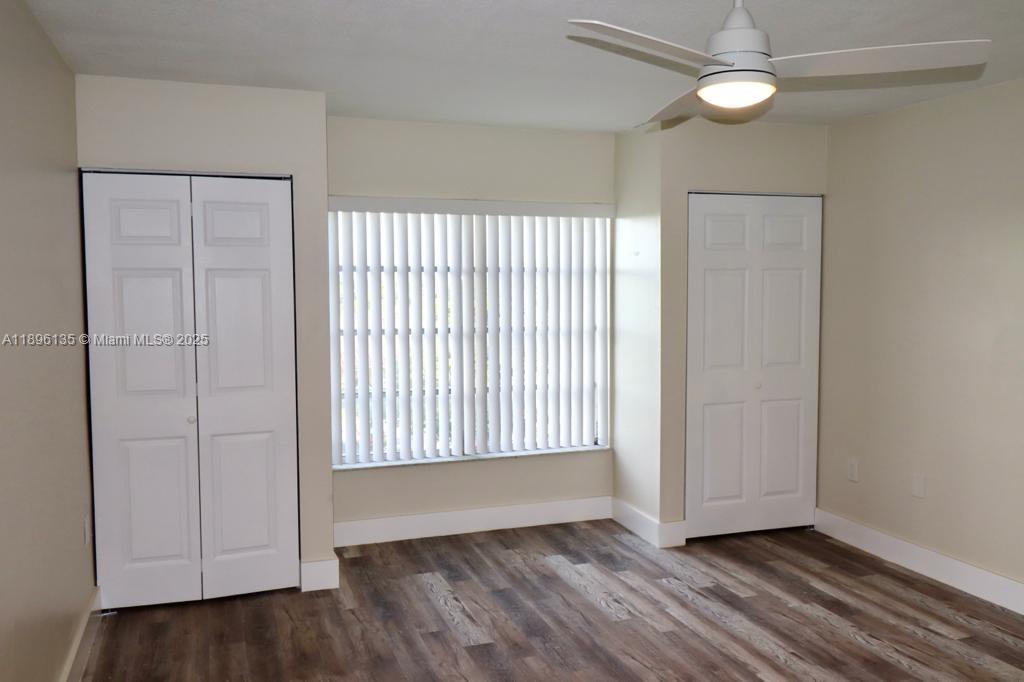 4164 Inverrary Drive, Unit 408 Lauderhill, FL 33319 - Photo 12 of 14 a view of an empty room with wooden floor and a window