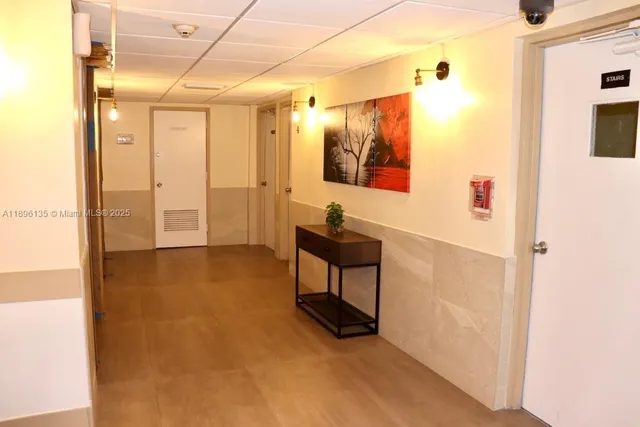 a view of a hallway with bathroom