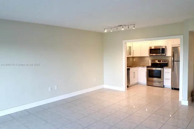 a kitchen with stainless steel appliances a refrigerator and a stove