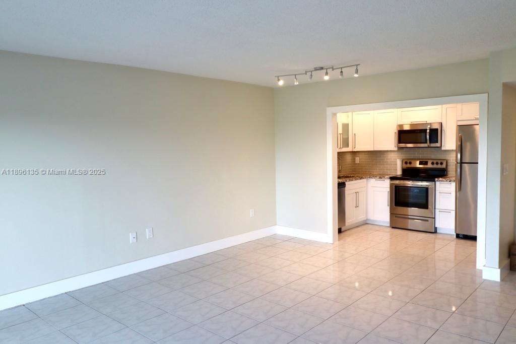 4164 Inverrary Drive, Unit 408 Lauderhill, FL 33319 - Photo 14 of 14 a kitchen with stainless steel appliances a refrigerator and a stove