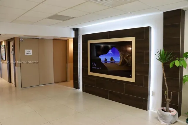 a view of a hallway with wooden floor and a fireplace