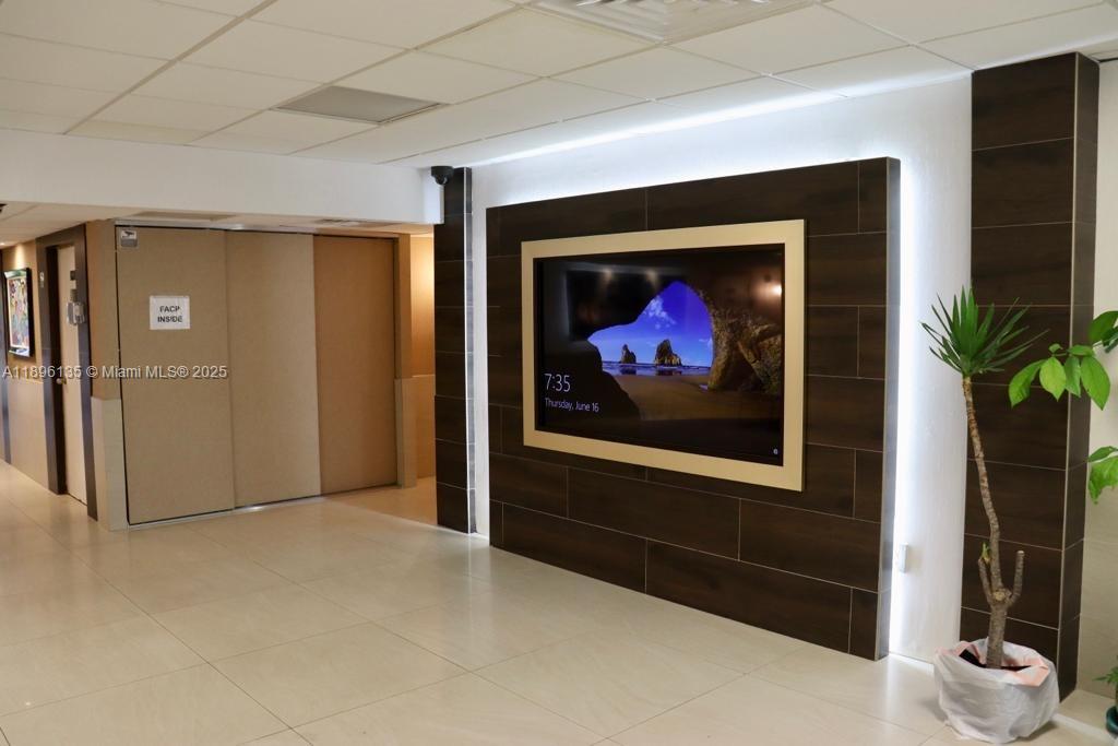 4164 Inverrary Drive, Unit 408 Lauderhill, FL 33319 - Photo 4 of 14 a view of a hallway with wooden floor and a fireplace