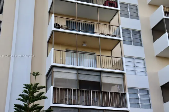 a view of balcony with small yard and wooden fence