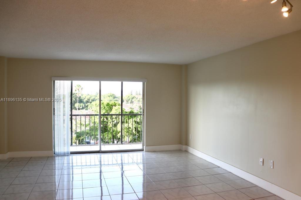 4164 Inverrary Drive, Unit 408 Lauderhill, FL 33319 - Photo 9 of 14 a view of an empty room with a window