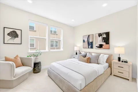 a bedroom with a bed and a couch