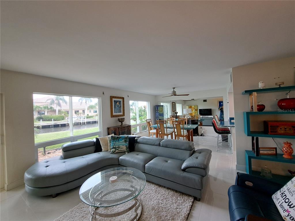 1 Colony Point Drive, Unit A5 Punta Gorda, FL 33950 - Photo 12 of 37 a living room with furniture and a large window